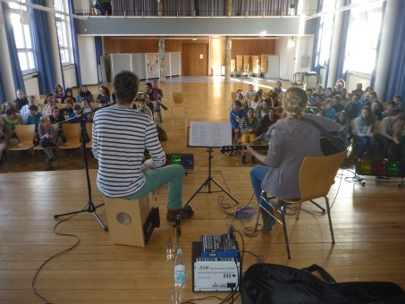 DIe beiden Musiker von hinten fotografiert mit Blick auf das Publikum.